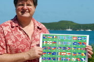 Photo d'archives: Jean-Raymond Postic, membre du comité de pilotage sur les signes identitaires, pose avec un dépliant où figurent plus de 80 idées de drapeaux pour la Nouvelle-Calédonie, le 20 avril 2007 à Nouméa. Alors que l'identité nationale a