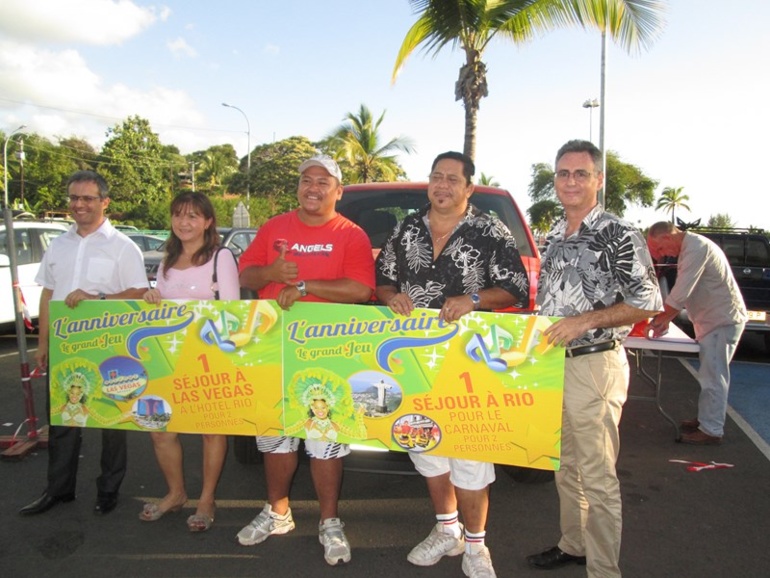 Nos trois gagnants du jeu Anniversaire Carrefour, posant aux côtés d'Eric Corlier, directeur de Carrefour Punaauia.