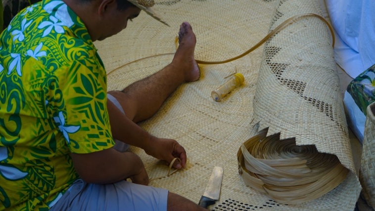 Papetai, en train de confectionner une natte ronde en pandanus.  Crédit : Tom Larcher