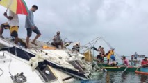 la police philippine inspecte le yacht au jour de la découverte d'un homme mort